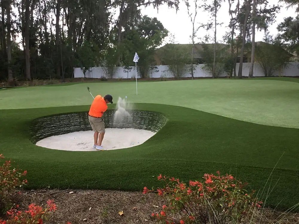 Bunker shot to par green with turf