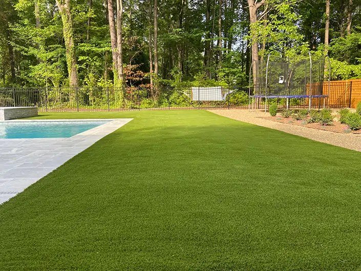 Backyard artificial grass pool area
