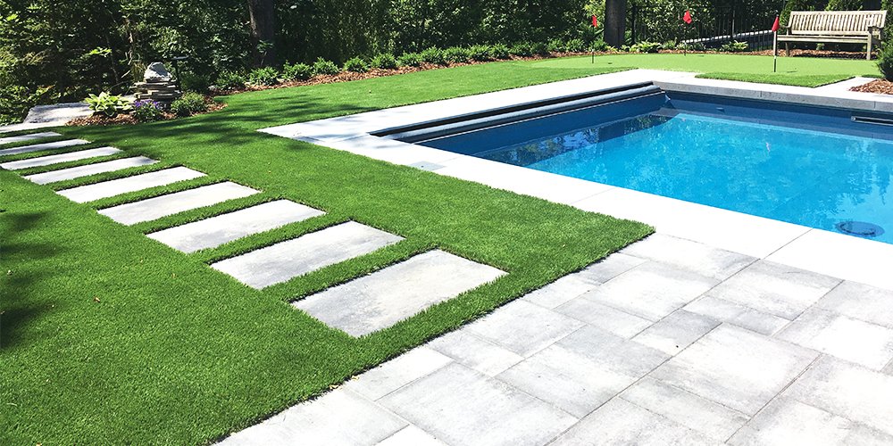 Pool deck pavers and turf with white stripe
